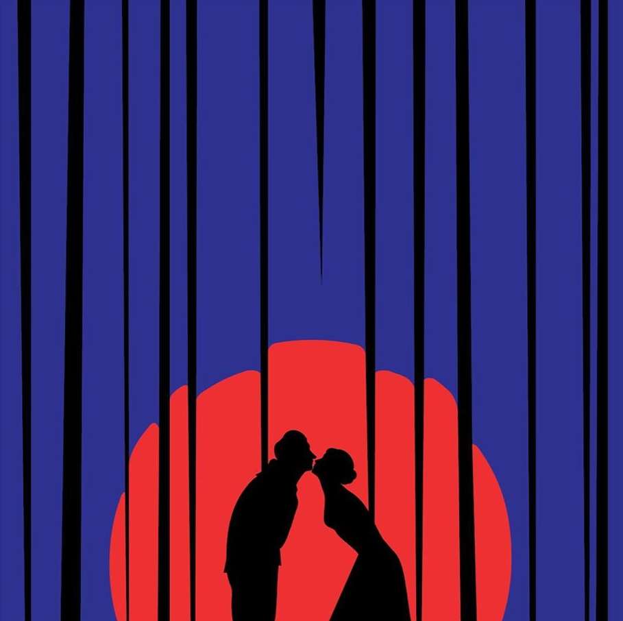 Silhouette of a couple in love sharing a kiss in front of a sunset framed by vertical stripes, creating a striking, romantic visual.