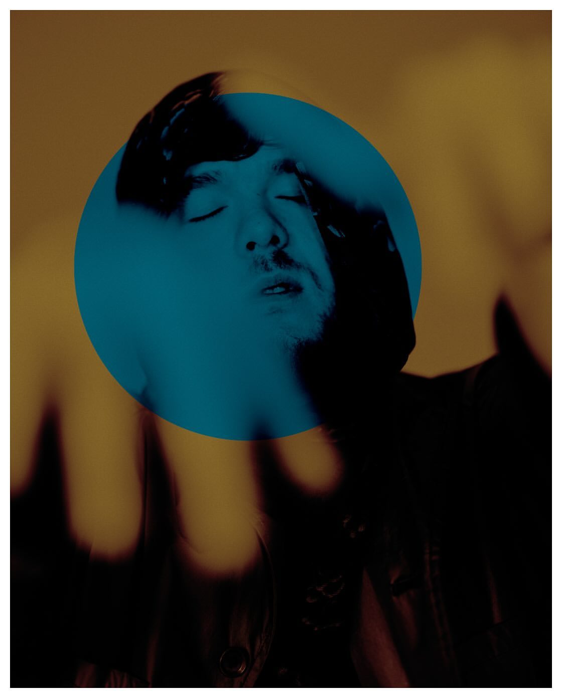 Portrait of a man with eyes closed overlaid with a bright blue circular geometric shape against a warm golden background