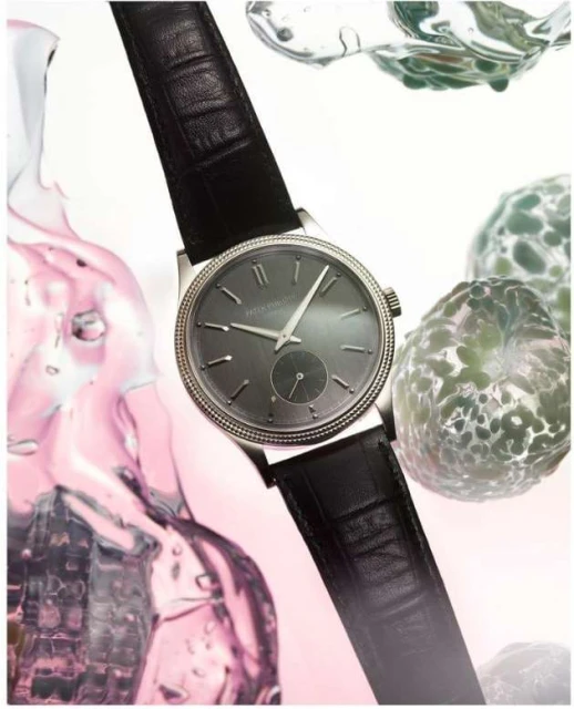 Elegant wristwatch with black leather strap displayed against a backdrop of abstract water droplets, suitable for luxury watch advertising.