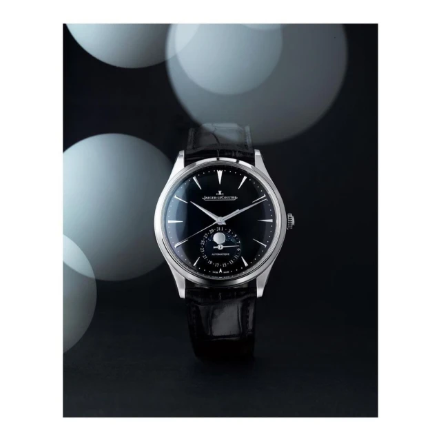 Luxury silver wristwatch with a black leather band on a dark background with white bokeh lights, elegant and stylish timepiece.
