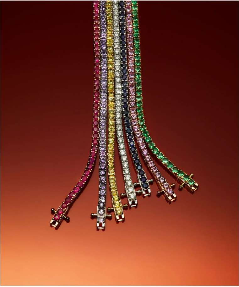Multiple gemstone bracelets in red, purple, yellow, white, black, pink, and green hues on a reddish-brown background, jewelry advertisement.