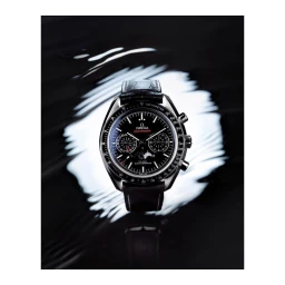 Close-up product photograph of a luxury chronograph wristwatch with black dial and leather strap resting on a dark reflective surface