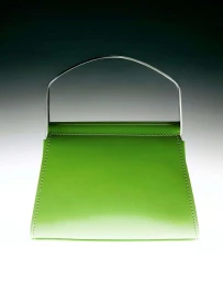 Bright green leather handbag with a metallic arch handle centered against a soft gradient background.