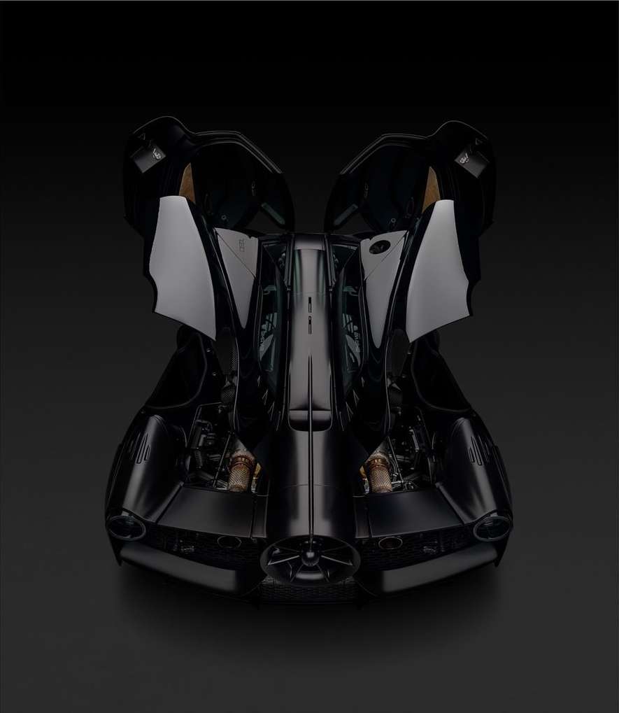 Sleek black car on a black surface shown in a studio shot from the front with its doors open for an interesting automobile product shot.