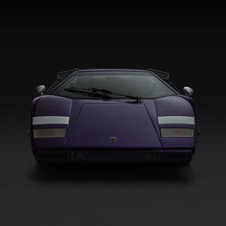 Frontal view of a purple Lamborghini Countach against a dark background, showcasing its iconic wedge shape and distinctive styling.