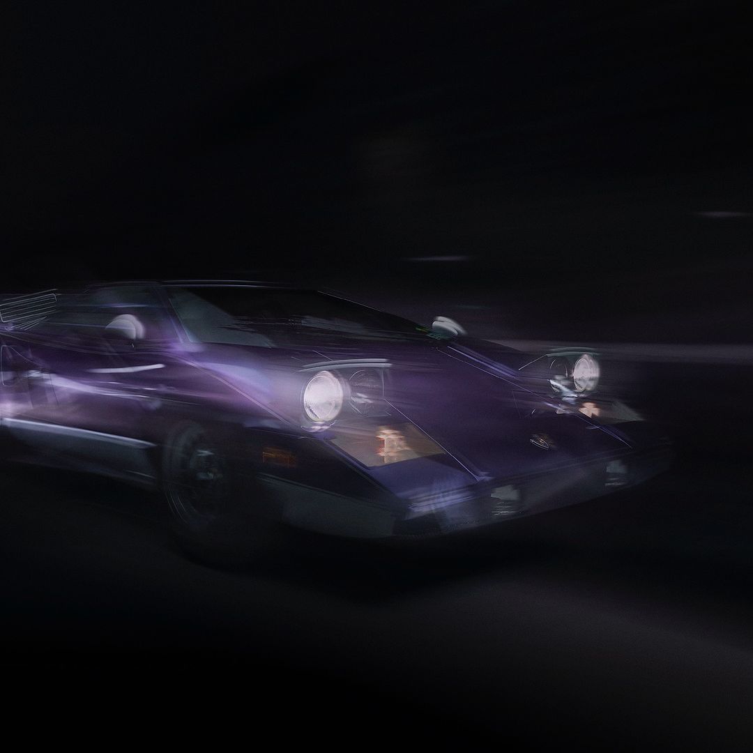 Close-up of a purple vintage car with headlights on against a dark background, showcasing automotive design and motion.