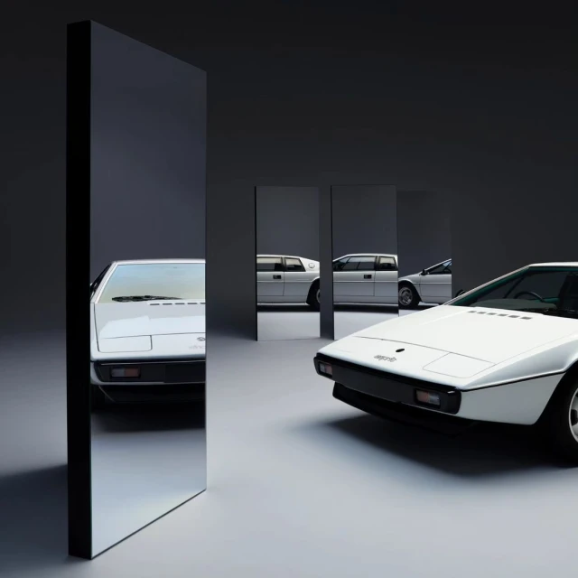 A sleek white Lotus Esprit automobile is showcased in a minimalist photo studio setting, flanked by reflective black panels.