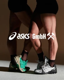 Two people wearing black shorts and sneakers with white Asics and GmbH branding overlaid on the legs in a studio setting