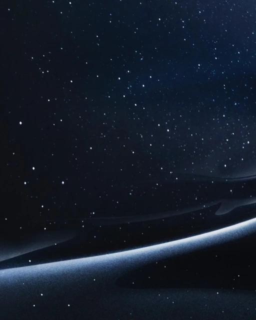 Night sky abstract background featuring a gradient of deep blues and blacks with a luminous band and scattered, bright starlike points.