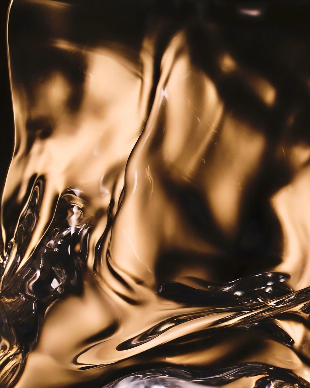 Abstract image featuring translucent material with ripples and reflections, set against a dark backdrop, creating an artistic composition.