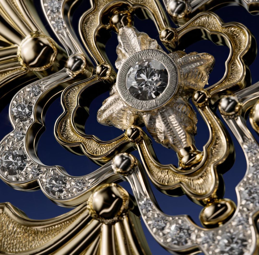 Ornate golden jewelry with diamond centerpiece on a dark blue background, showcasing intricate metalwork and craftsmanship.