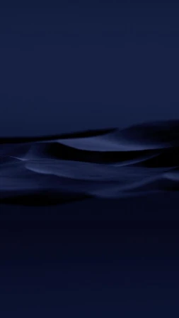 Abstract photograph of rolling, dark blue-toned dunes in a minimalist composition, evoking mystery and tranquility.