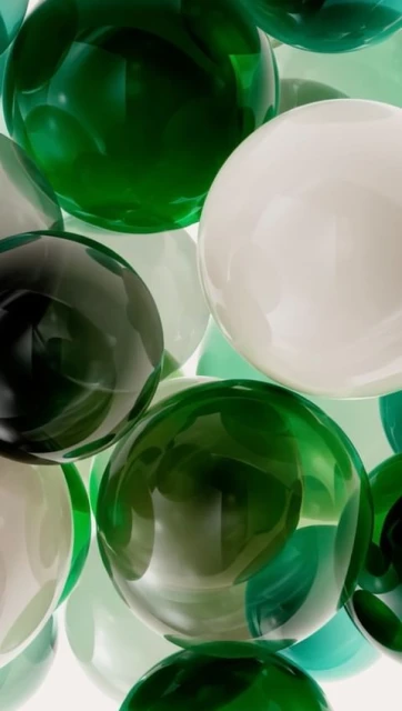 Abstract arrangement of green and white spheres creating a visually interesting and colorful background, showcasing depth and reflection.