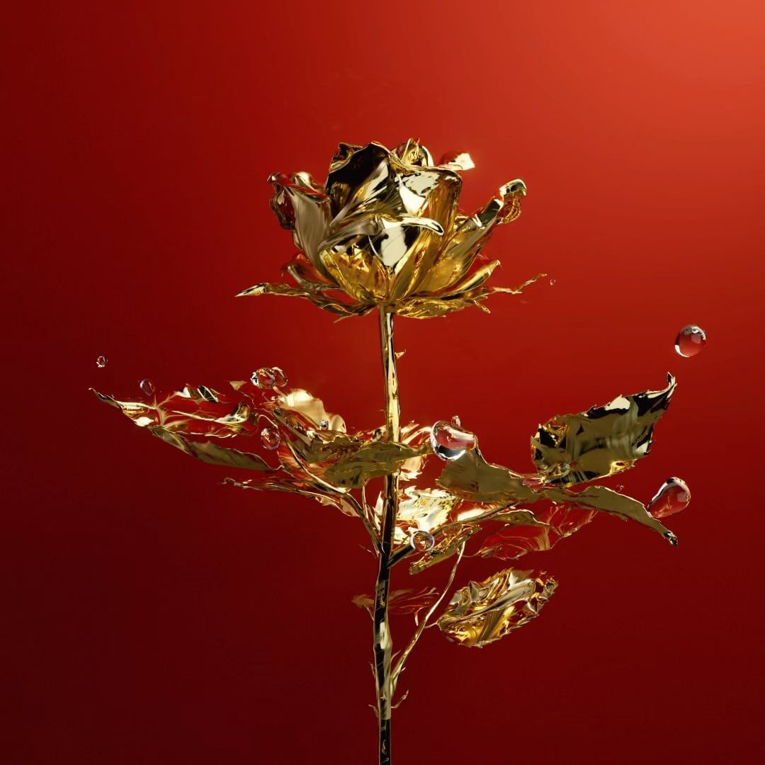 Striking image of a gold-plated rose with water droplets, set against a rich red background creating a luxurious aesthetic.