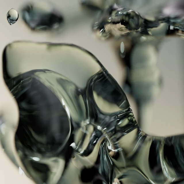 Abstract close-up of smooth, shiny, translucent forms with subtle color gradients, suggesting water or glass in a studio setting.