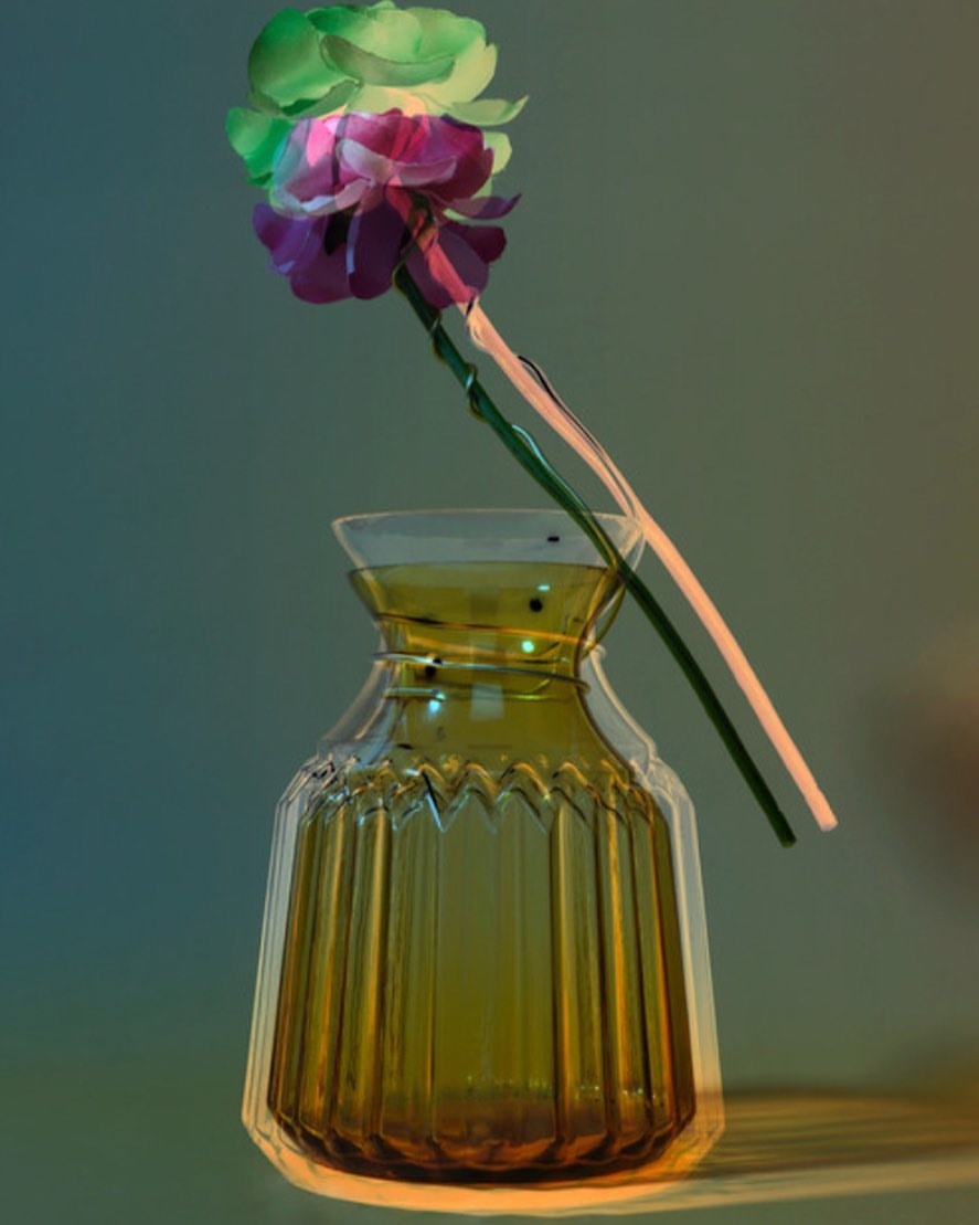Close-up still life of a green and purple flower arrangement in an olive-green decorative glass vase, indoor studio setting with soft lighting.