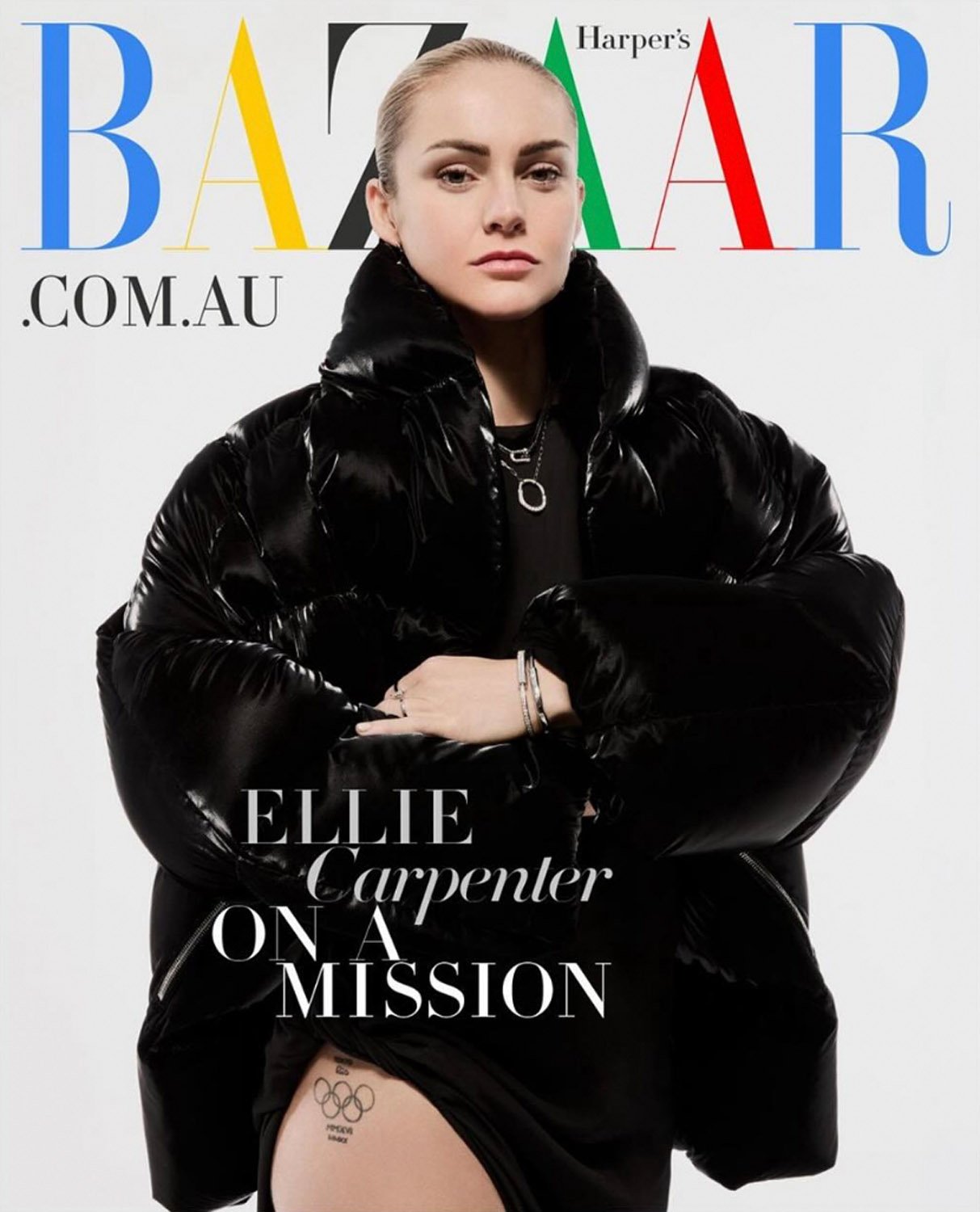 Ellie Carpenter on Harper's Bazaar cover in a black puffer jacket against a white backdrop, featuring Bazaar masthead and tagline.