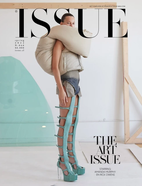 Fashion editorial magazine cover of a woman wearing avant-garde clothing with large puffer attachments and sculptural high-heeled shoes.