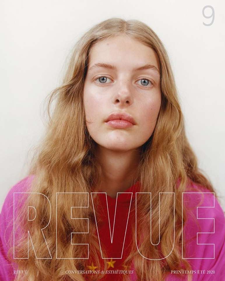 Close-up portrait of a young woman with blonde hair wearing a pink sweater, featuring magazine text overlay on a white background.