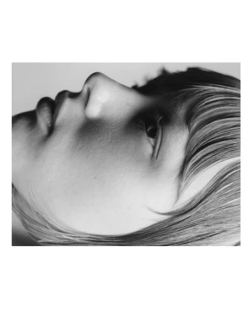 Close-up monochrome side profile portrait of a person with straight hair by Benjamin Vnuk.