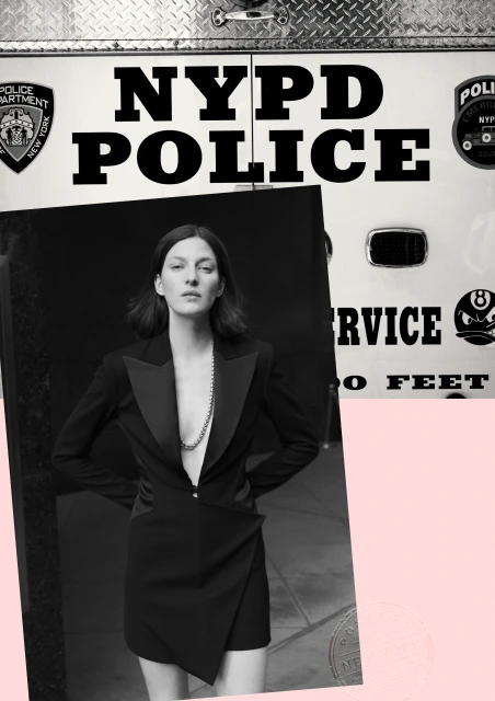 A woman in a black blazer dress stands in front of an NYPD vehicle with prominent typography. The image is partially overlayed with a pink shape.