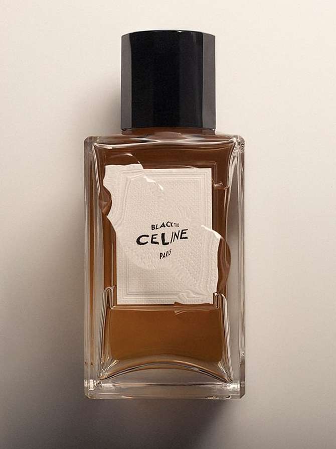 Still-life studio shot of a CELINE Black Tie fragrance bottle with a black cap and a beige label on a neutral background.