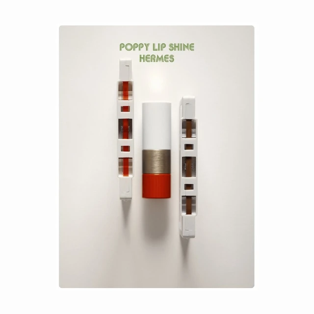 Hermes Poppy Lip Shine with white and red lipstick tube displayed on white backdrop with product packaging.