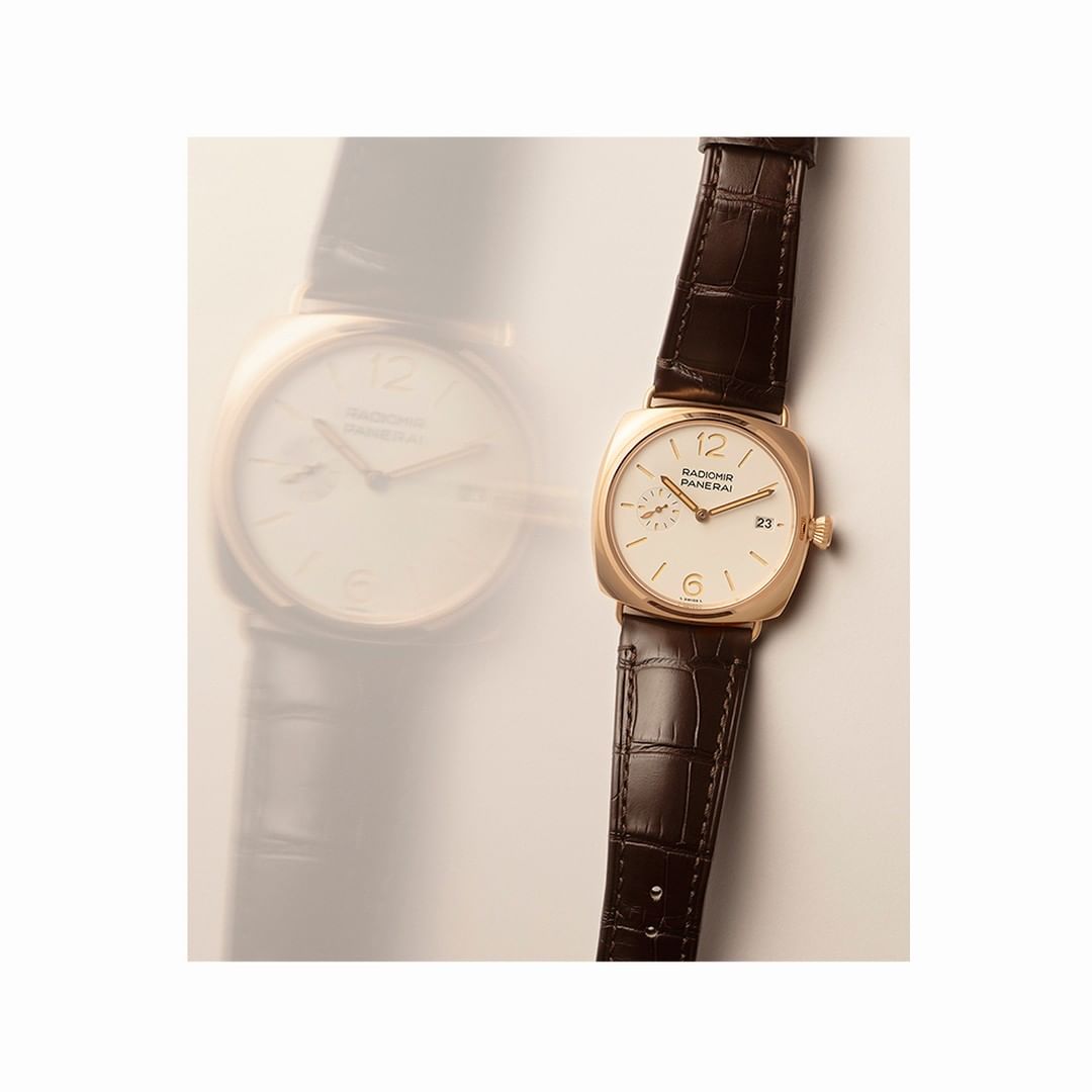 Elegant gold Panerai Radiomir watch with a dark brown leather strap, featuring a white dial, gold hands, and small date window.