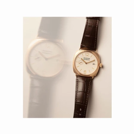 Elegant gold Panerai Radiomir watch with a dark brown leather strap, featuring a white dial, gold hands, and small date window.