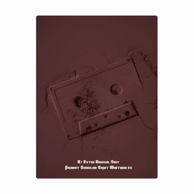 Vintage audio cassette tape artfully depicted with pigmented powder, showcasing a unique blend of retro media and artistic expression.
