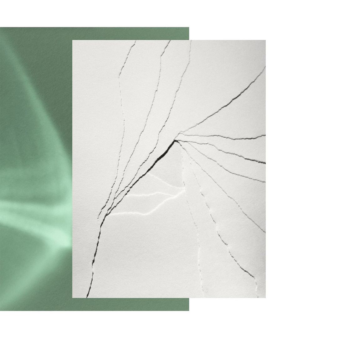 Abstract image featuring white marble with dark veins, set against a green and white background, showcasing natural stone textures.