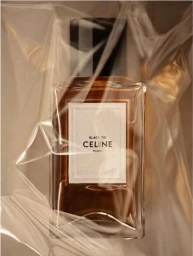 Celine perfume bottle wrapped in creased clear plastic film creating abstract light reflections