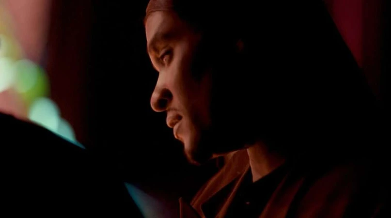 Profile portrait of a man in dim lighting with warm highlights captured by Bethany Mollenkof.