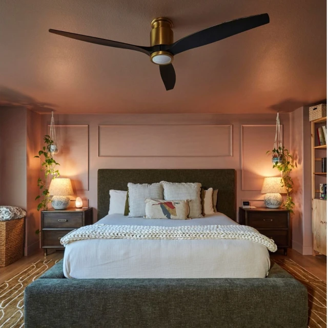 Bedroom interior features a green upholstered bed with white bedding and pillows, flanked by wooden nightstands, under a black ceiling fan.