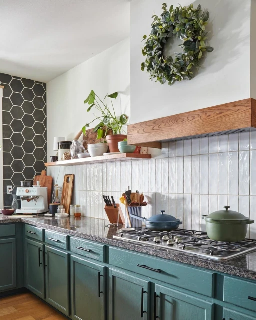 Modern teal kitchen with granite countertops, featuring stainless steel appliances, light tile backsplash, and wooden accents. Home interior.