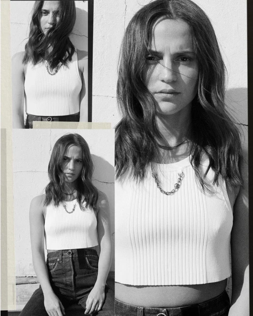 Monochrome shot of a woman with long hair wearing a white top and jeans, posing in front of a textured wall in three panels.
