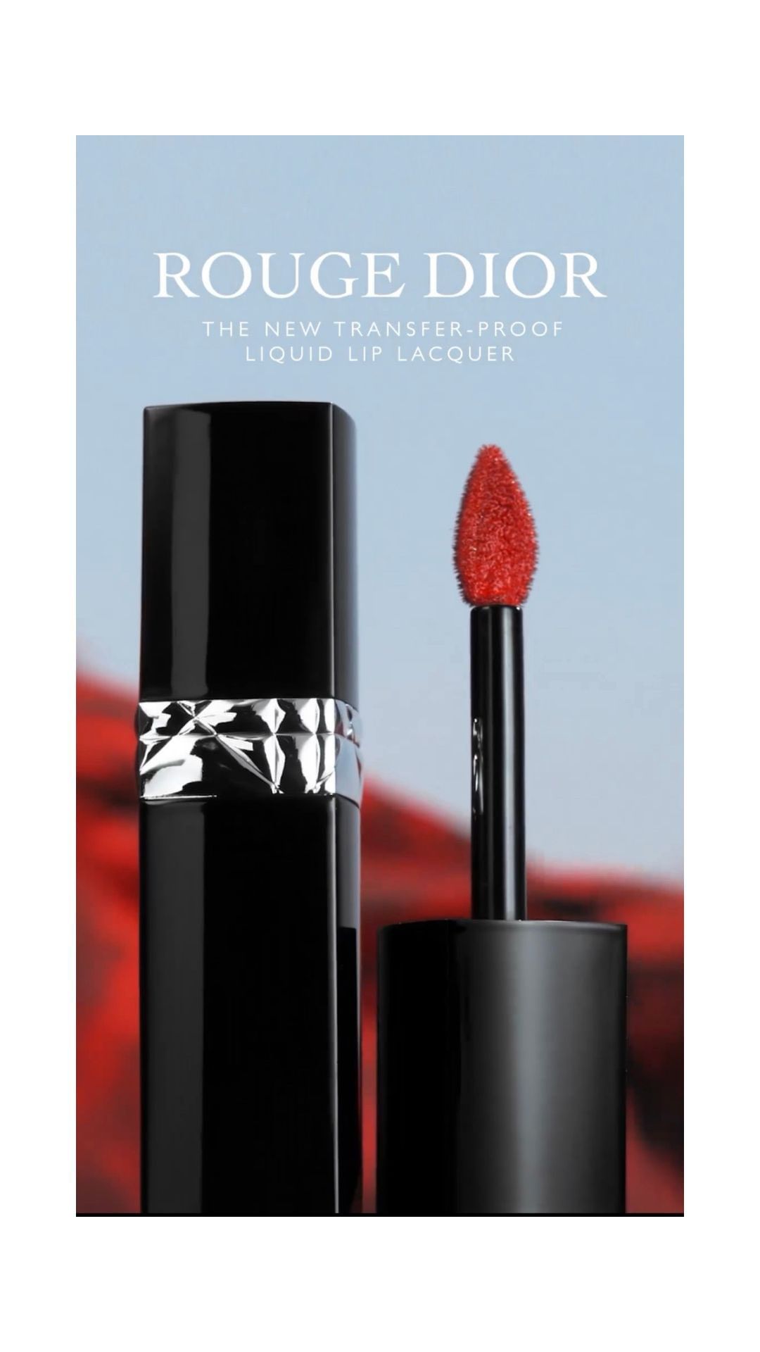 Rouge Dior liquid lip lacquer in black packaging with a bright red applicator against a blurred background in a studio shot.