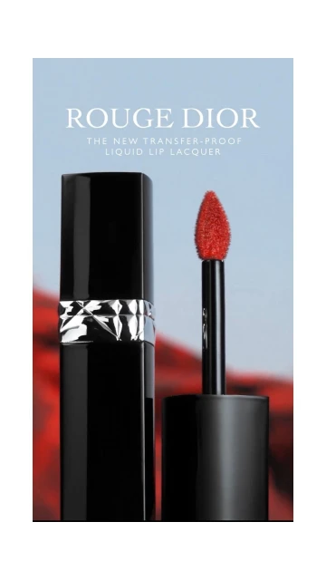 Rouge Dior liquid lip lacquer in black packaging with a bright red applicator against a blurred background in a studio shot.