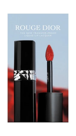 Rouge Dior liquid lip lacquer in black packaging with a bright red applicator against a blurred background in a studio shot.