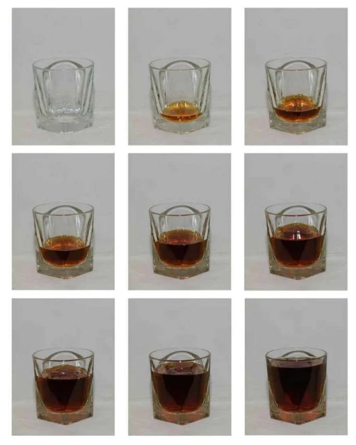 Progression of whiskey being poured into a clear, faceted rocks glass, filling it to the brim across nine sequential frame captures.