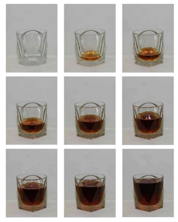Progression of whiskey being poured into a clear, faceted rocks glass, filling it to the brim across nine sequential frame captures.