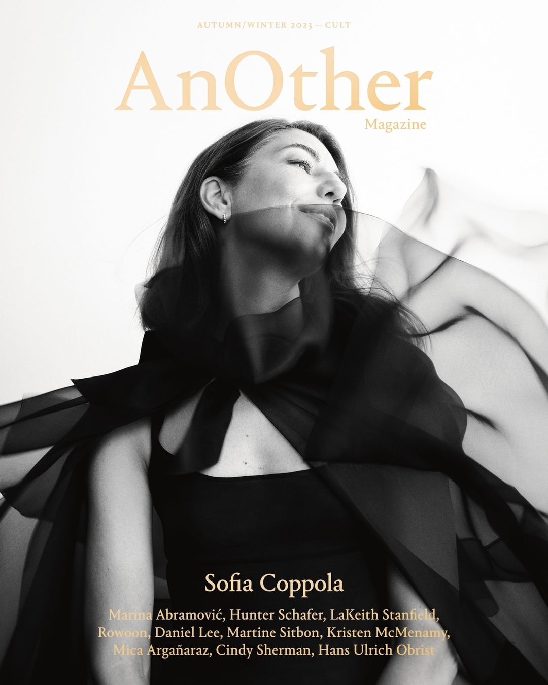 Sofia Coppola gazes upward on a magazine cover with black sheer fabric draping over her. The magazine title 'AnOther' appears at the top.
