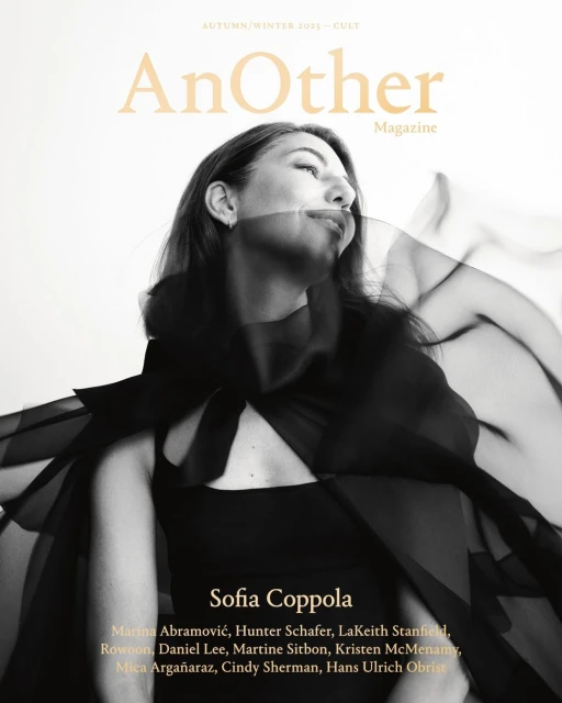 Sofia Coppola gazes upward on a magazine cover with black sheer fabric draping over her. The magazine title 'AnOther' appears at the top.
