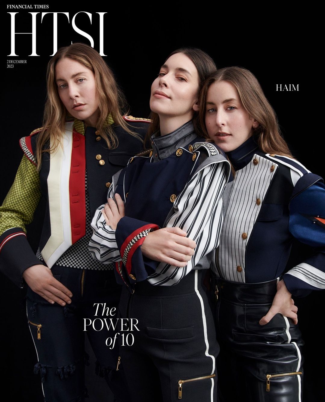 Three women wearing military-inspired fashion pose on the cover of Financial Times HTSI, December 2023 issue, against a black background.