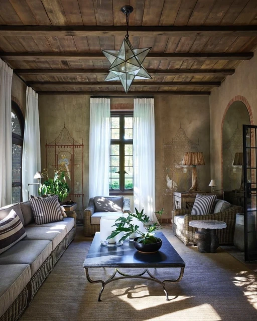 Cozy living room interior showcasing a neutral-toned sofa, coffee table, and star-shaped pendant light, creating a warm and inviting space.