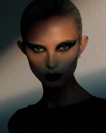 Close-up portrait of a woman with dramatic dark eye makeup and lipstick, captured in low-key moody lighting by Blair Getz Mezibov.