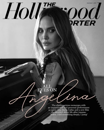 Black and white magazine cover featuring Angelina Jolie with long hair and fair skin in soft light, with piano keyboard detail.