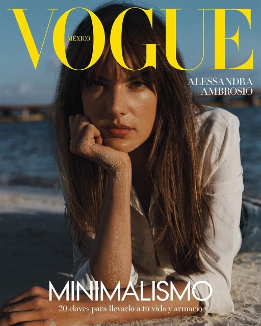 Alessandra Ambrosio on Vogue Mexico cover, laying on the beach. She is wearing a white shirt and looking at the camera.