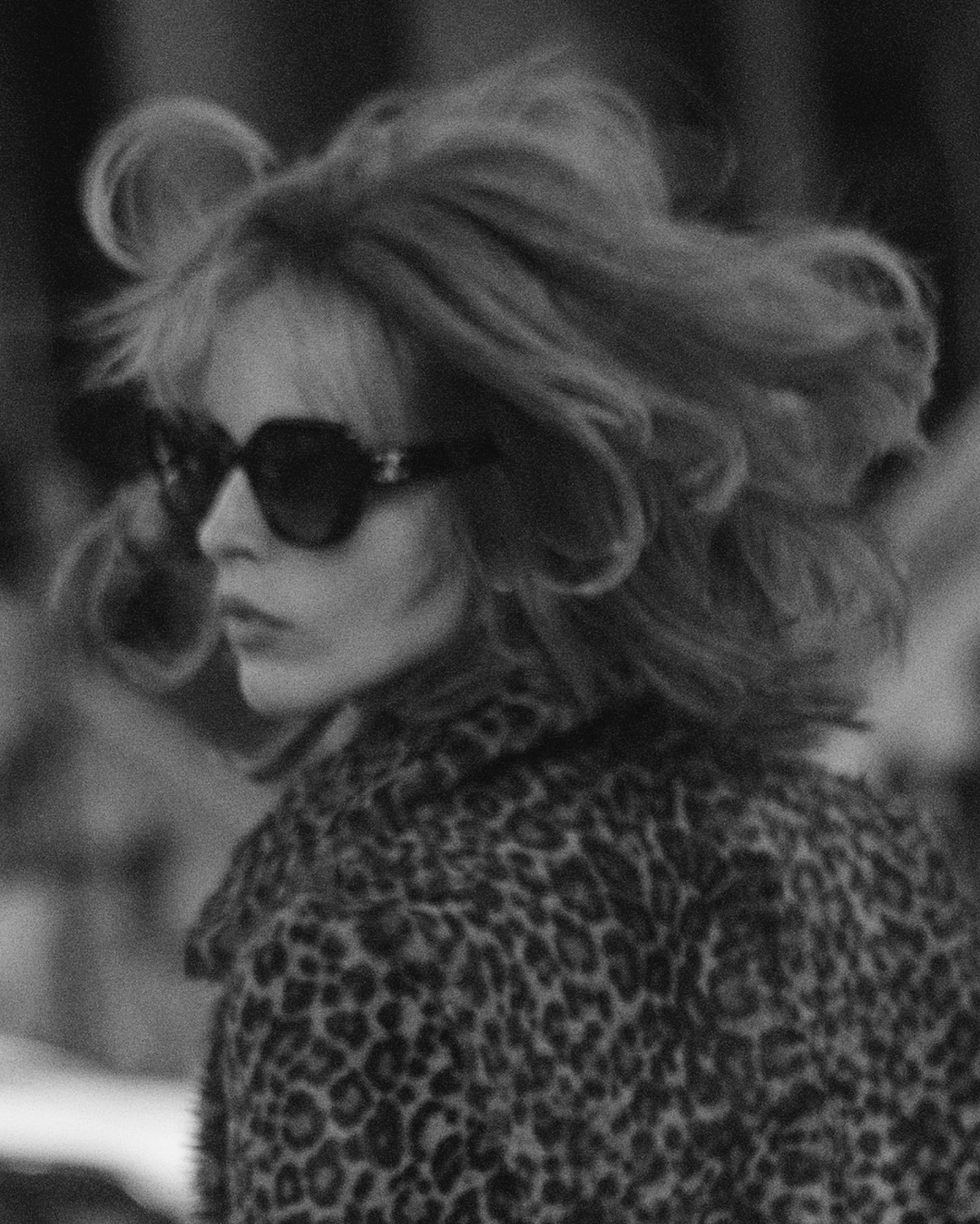 Monochrome portrait of a woman with voluminous hair wearing sunglasses and a leopard print coat by Blair Getz Mezibov