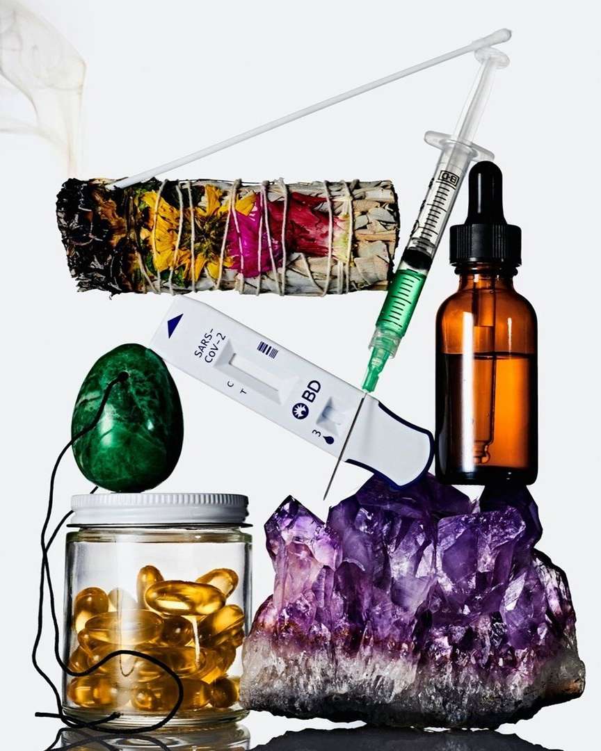 Still life with COVID-19 test, sage, syringe, capsules, and crystal. A conceptual blend of health, healing, and scientific tools.